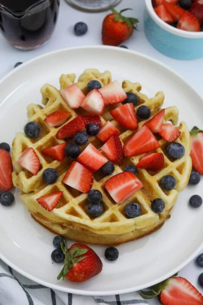 A plate of Belgian waffles with fresh fruit