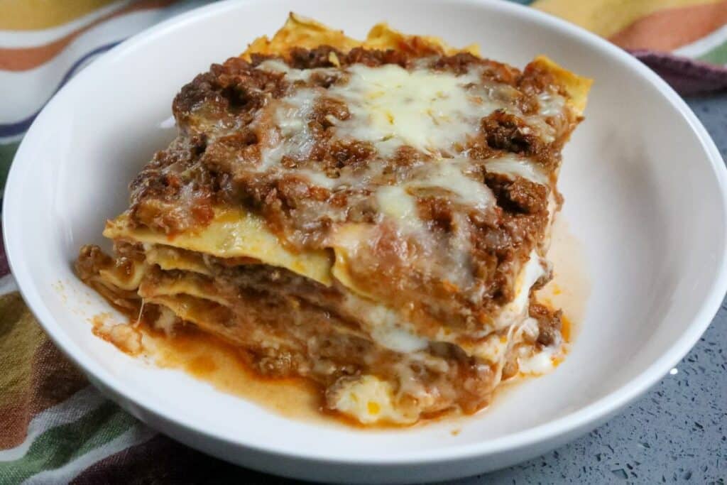 Close up of lasagna in a white bowl