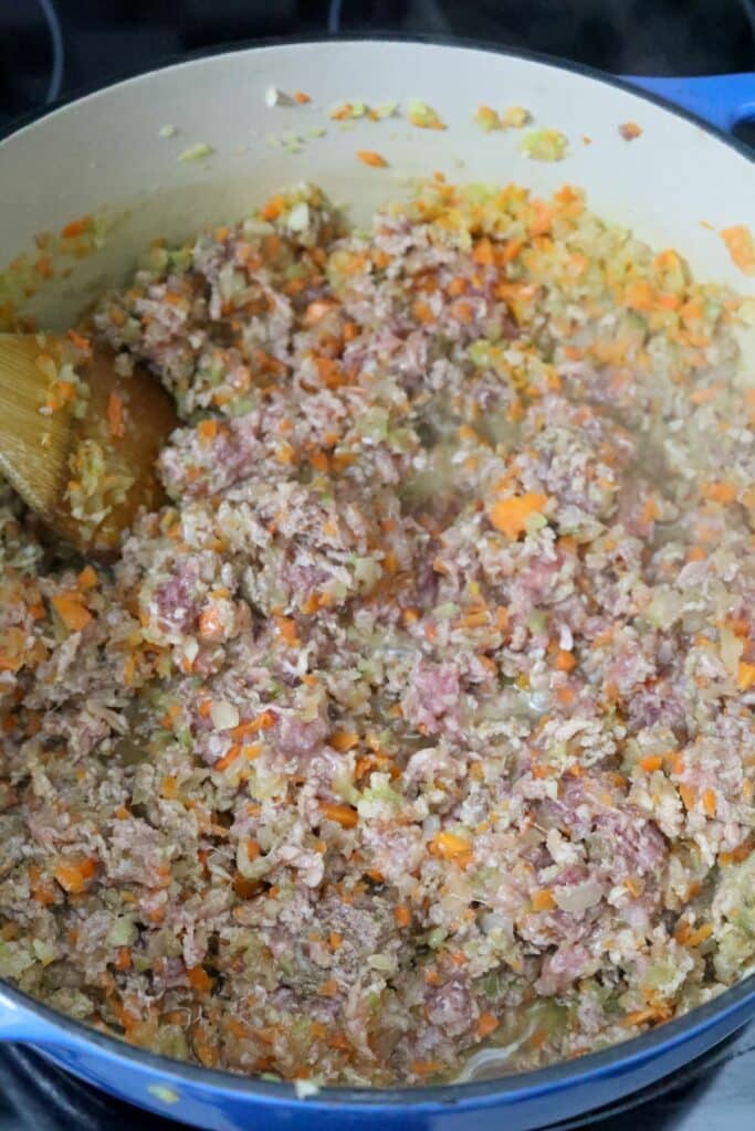 Adding ground beef and pork to mirepoix in a Dutch oven